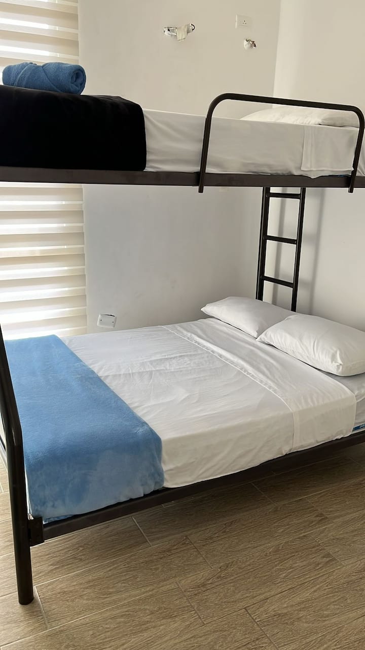 Room with a bunk , has fan, closet.