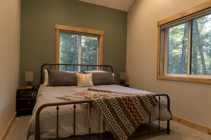 King sized bed located on the top floor in the loft, along with an attached bathroom. 
extra sheets
books
towels
face tissues 
black out blinds
lamps with outlets for easy charging