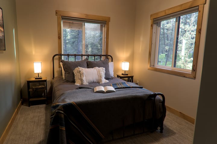 Queen sized bed located across the hall from the main floor bathroom.  Located on the main floor by the kitchen and living room.
