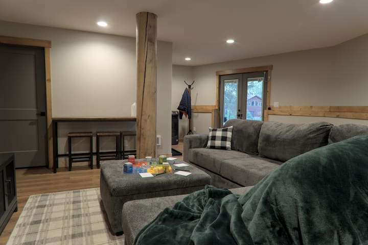 Cozy gaming and movie theater living room on the bottom floor. Located where you enter into the home.  Games and puzzles and Wii console are provided here along with blankets and a TV. Shades can be lowered to provide a dark space for movie viewing.