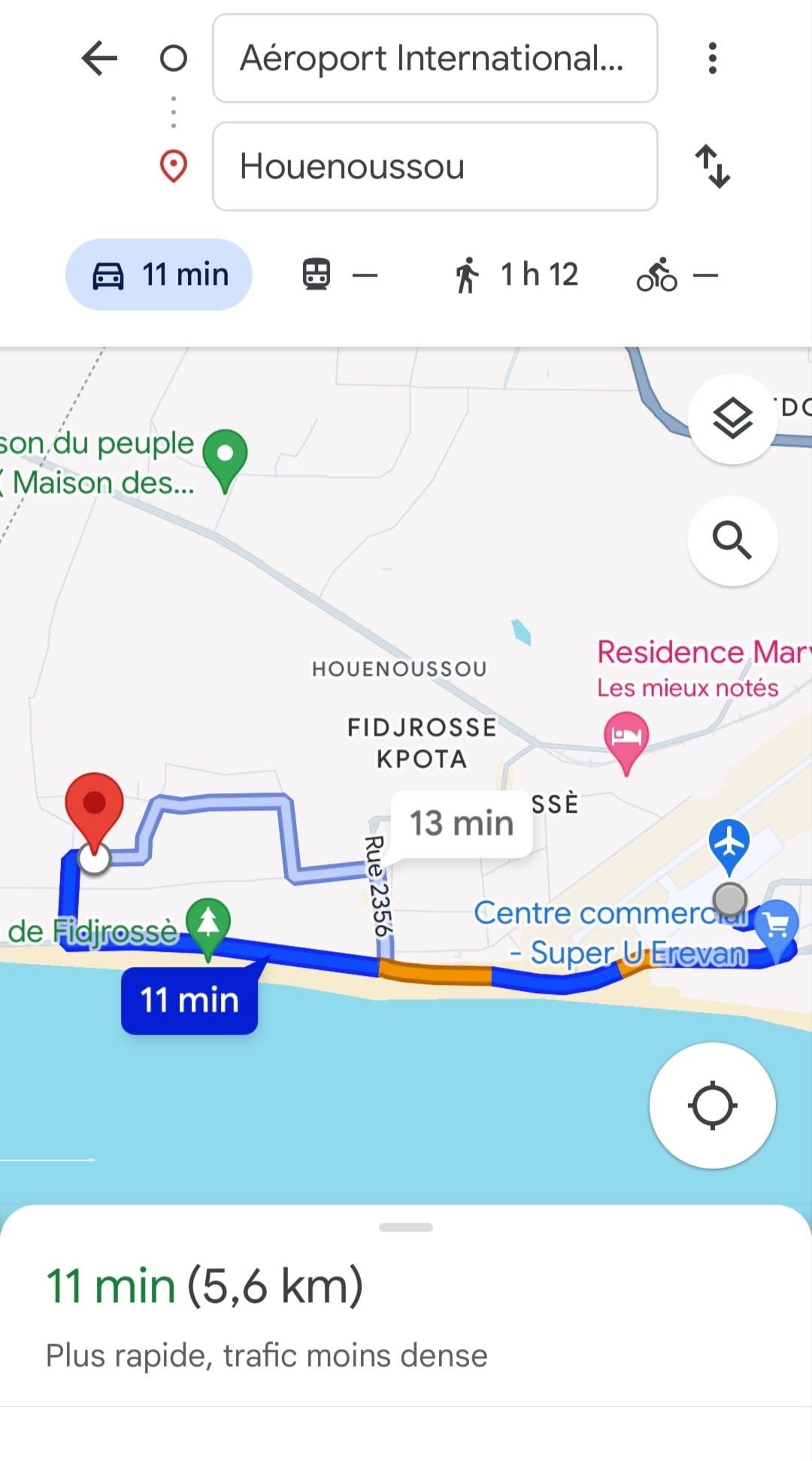 A map illustration shows a route from the airport to the Fidjrossè beach area. The route is highlighted in blue, indicating a travel time of 11 minutes. Landmarks and nearby roads are marked, providing clear navigation guidance.
