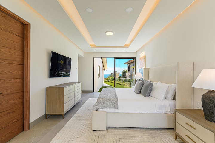 Relax and unwind while catching up on your favorite TV shows in bed, complete with a large smart TV for your entertainment.