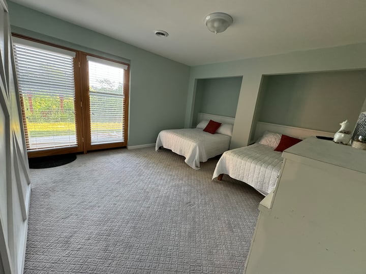 The walkout basement level "Bunker Room" has three full beds including a murphy bed and a full bathroom in the adjoining hall.