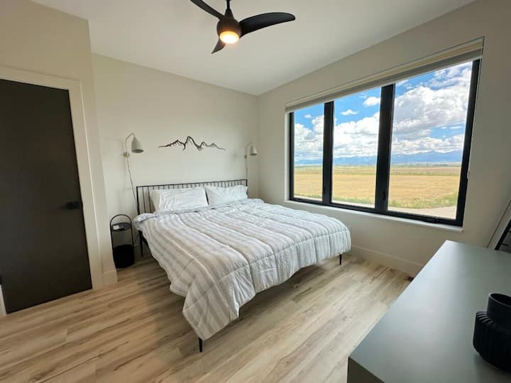 Glavna spavaća soba gleda na planine Teton i ima veliki TV.