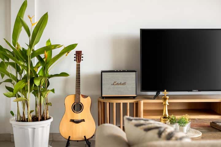 Featuring a classic guitar and a premium Marshall speaker for an inviting musical ambiance for our guests.