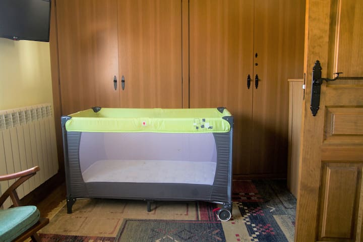 سرير أطفال في غرفة بسريرين