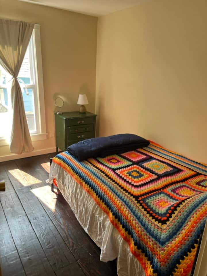 Full bed with closet and dresser for extra storage; blackout curtains