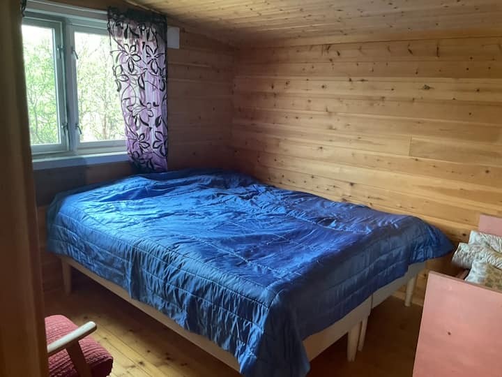 Gran cama de hotel y una pequeña cama de bebé.