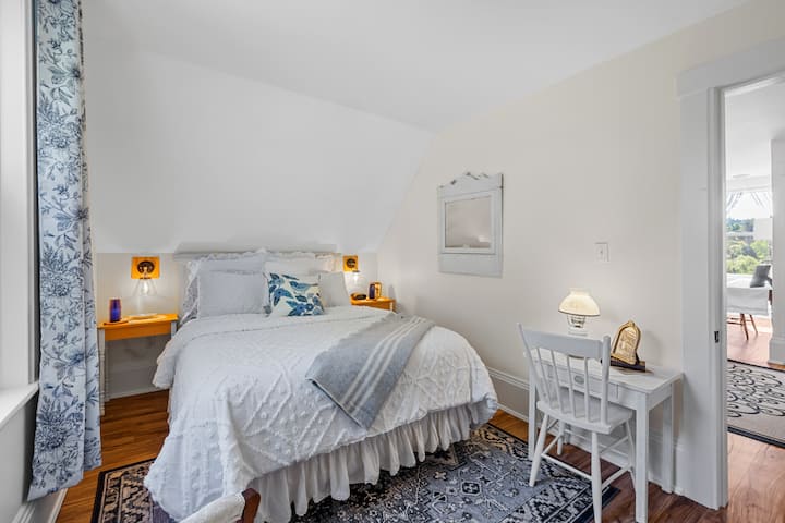 Meadow Suite workspace or reading space with queen bed