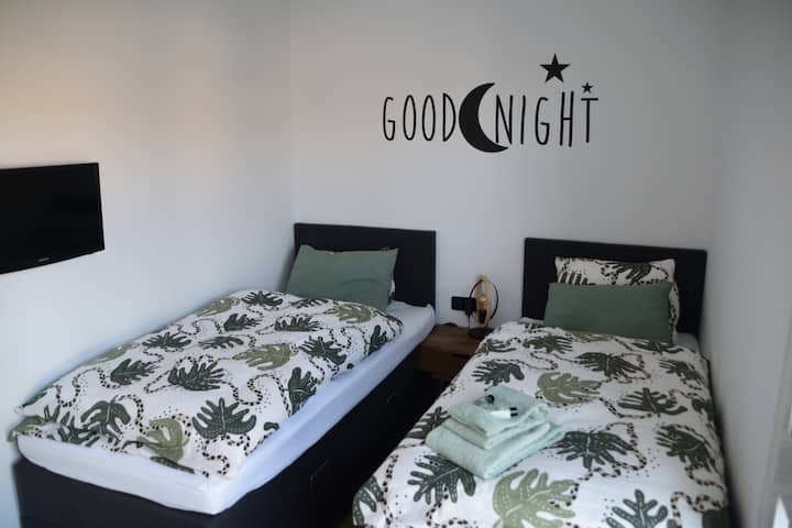 Vitanda viwili vya mtu mmoja. Chemchemi ya sanduku iliyo na droo ya kuhifadhi. soketi ya ukuta. Televisheni yenye ushirikiano na muunganisho wa data. 