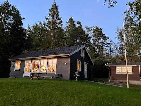 Cozy cabin by the lake with wood-fired sauna