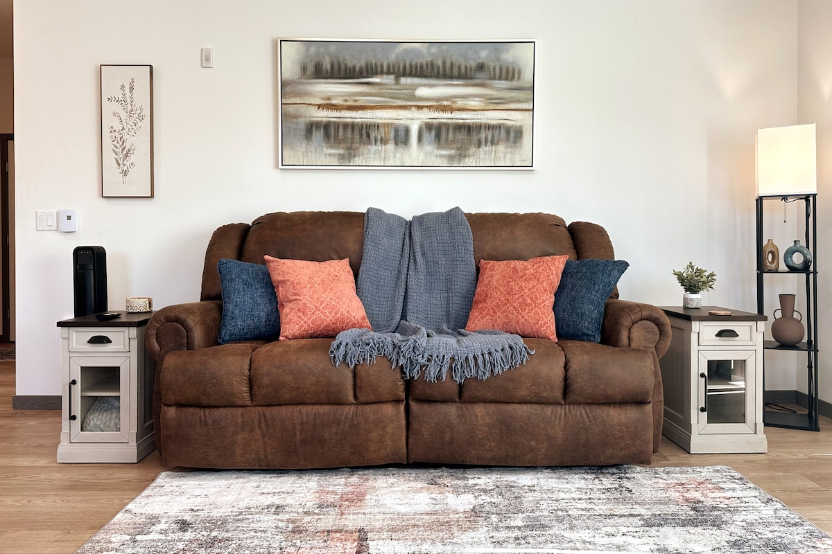 Living Room Space with brand new comfy couch that reclines on both ends.