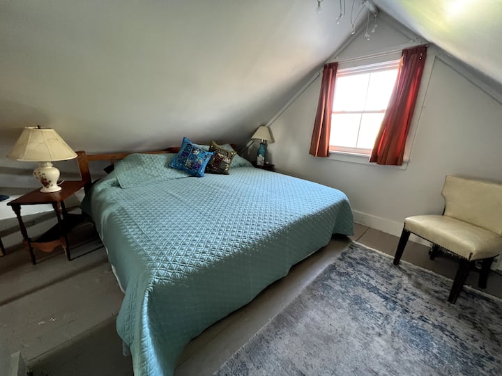 King sized bed in a cozy corner looking out toward the sunrise.