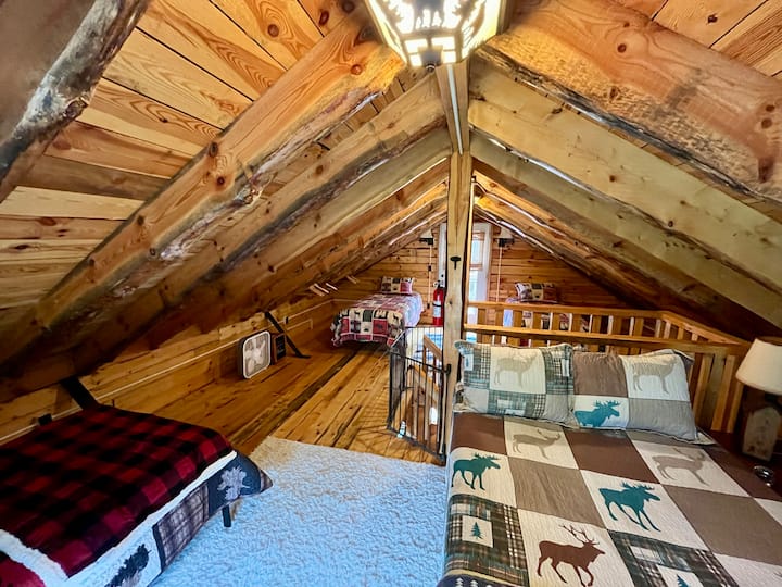 Our cozy loft bedroom features one full and three twin beds, perfect for families or friends.
