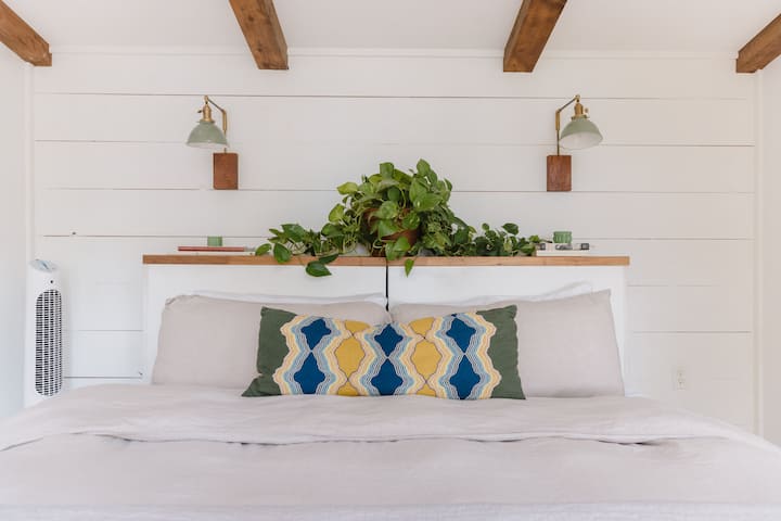 Bedroom with a king size bed and crisp linens. This bed can be made into twins upon request.