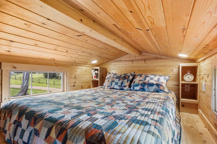 The loft of the Lapis Cottage has a queen sized bed, a smart television and an amazing tree house-like view of the farm.