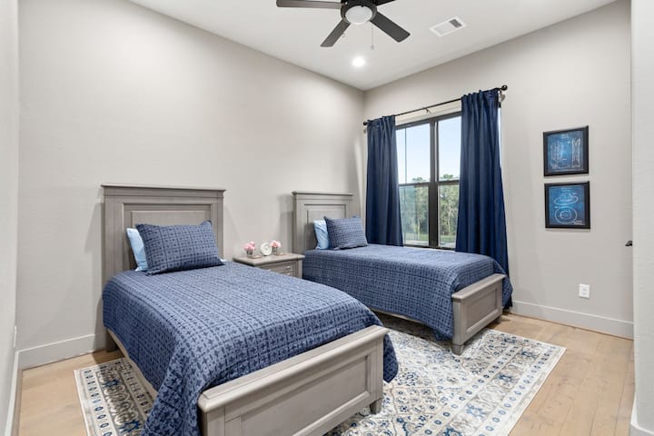 The secondary bedroom has two twin beds with luxury cotton bed linens, quilts and blankets.