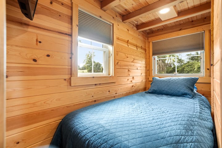 The twin bedroom area downstairs includes a smart television.