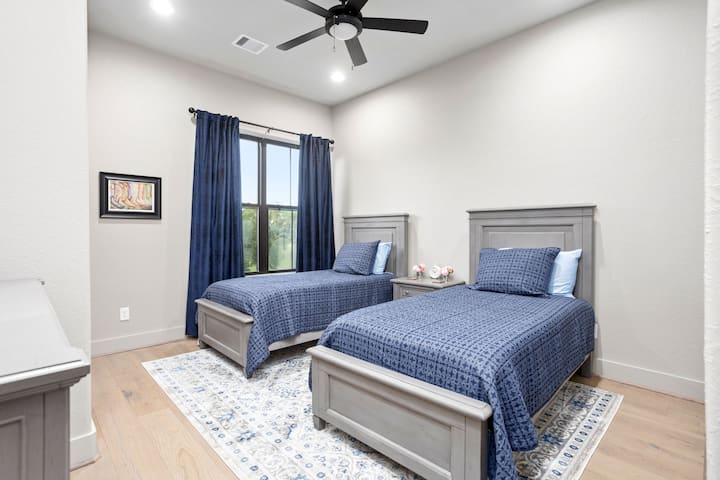 The secondary bedroom has two twin beds with luxury cotton bed linens, quilts and blankets.