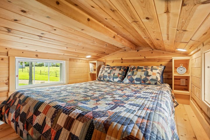 The loft of the Ruby Cottage has a queen sized bed and an amazing tree house-like view of the farm.