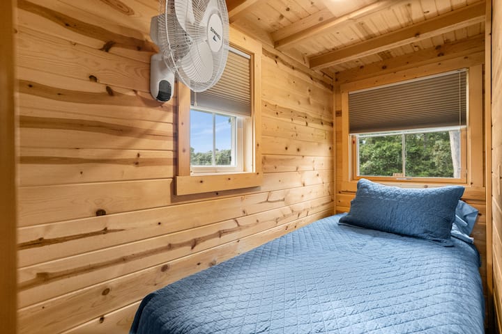 The twin bedroom area downstairs includes a smart television.