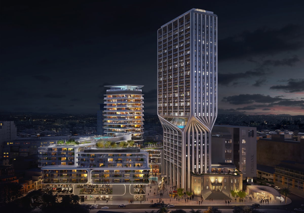 The Mercury Towers stand elegantly at night, featuring a modern architectural design. The taller tower has a unique twisting shape, while the lower block displays a mix of glass and greenery. Warm lights illuminate the surroundings, creating a vibrant atmosphere in the newly developed cultural hub.