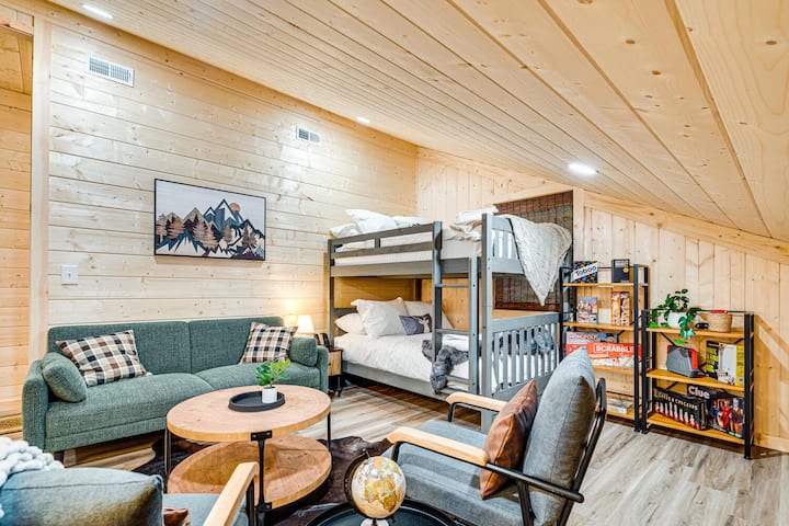 Living Room 2 is designed for fun and relaxation, with a sofa, chairs, and a set of bunk beds. It also includes a variety of board games, making it a perfect space for kids or family game nights.