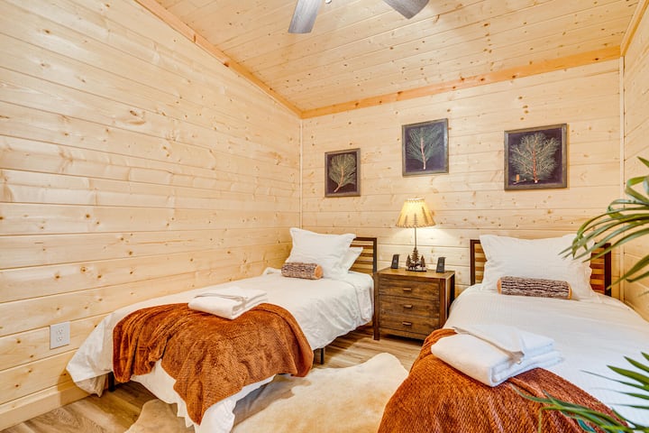 Bedroom 4 features two twin beds and two wireless charging stations, providing comfort and convenience for guests.