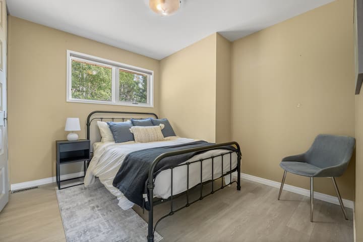 חדר שינה שני בקומה הראשית עם מיטה זוגית וארון.