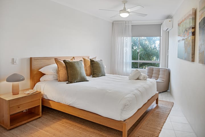 Retreat to the calming primary suite with air conditioning, plush bedding, and natural tones for restful nights.