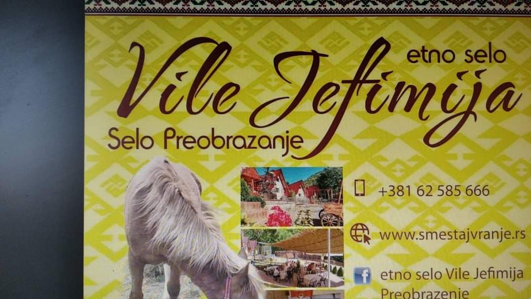 A colorful sign for Etno Selo Vile Jefimija features a graphic of a horse alongside images of the accommodation. The background showcases traditional patterns, while contact information and a website are clearly displayed, indicating hospitality and local charm.