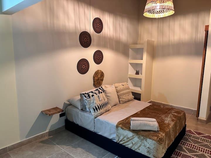 Gezellige, moderne ruimte met etnische stijl en handgemaakte details. Het biedt een warme, rustige en ingerichte sfeer. Met een tweepersoonsbed, zachte verlichting en een bohemien tintje.