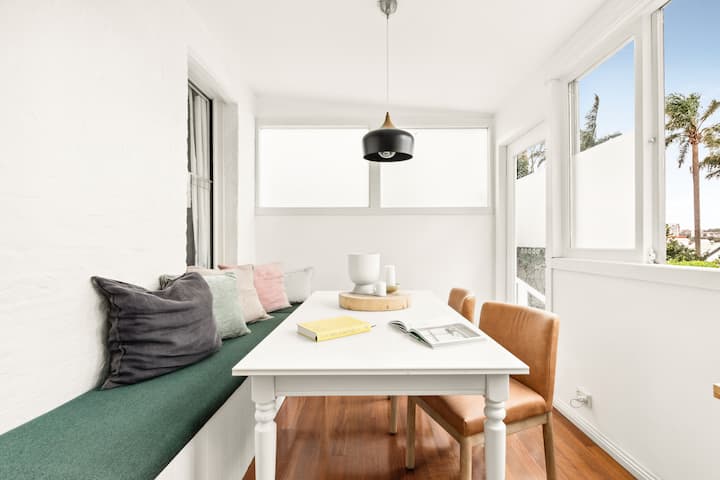 Bright and airy dining area, perfect for enjoying meals or reading with a view. Features cozy bench seating with fun colourful cushions, which makes for a relaxed & inviting atmosphere.