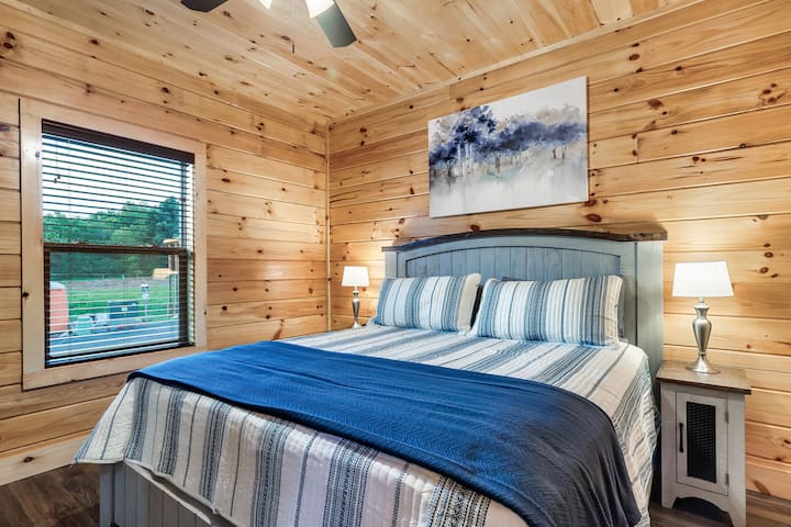 Experience the epitome of comfort in our king bedroom, complete with a 43" streaming smart TV. Admire the serene decor as you enjoy the convenience of an ensuite bathroom. Relax and unwind in style amid rustic charm and modern amenities.