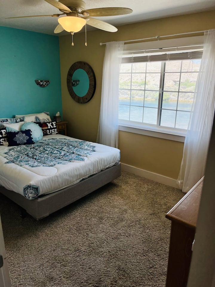 Carpeted second Bedroom with a beautiful view of the River, better than the Master !   Ceiling fan and Light, 2 dressers and closet.