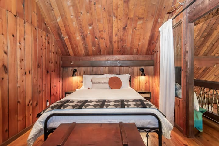 Queen bedroom upstairs blackout curtains to create full privacy from loft, sound machine