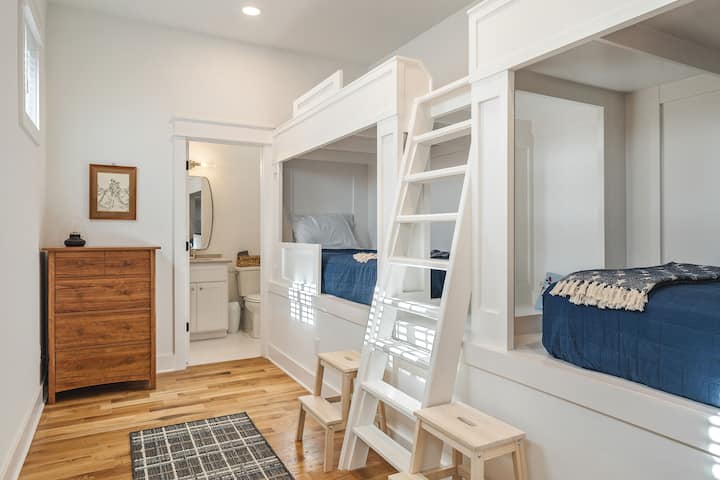 Bunk room featuring 4 twin size beds and private bathroom with shower.