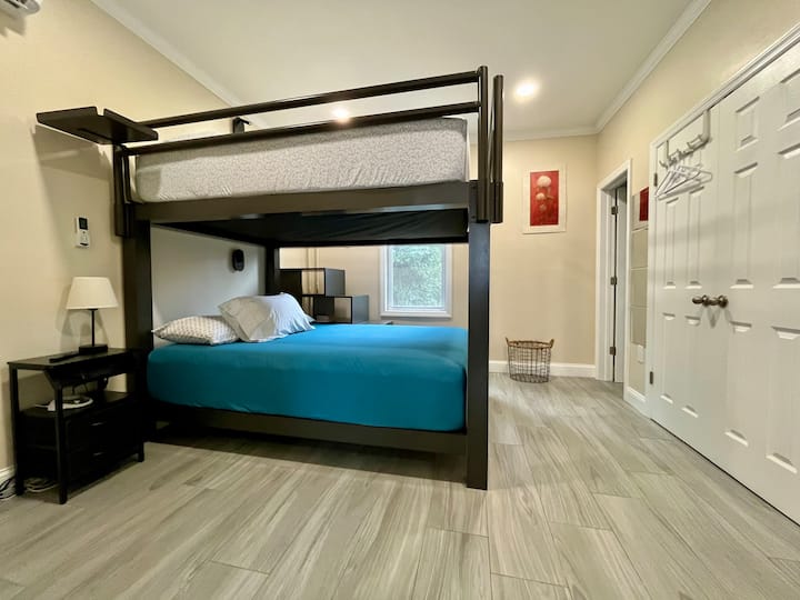 Two Queen size mattresses.  Staircase to top bunk
Wall sconce lighting - easy to reach while in bed
Build in USB ports for mobile device charging
Wall mount iron board with Iron
Wall mount smart TV with local channels
Nightstand
Closet
Luggage stand