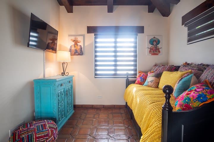 Bedroom upstairs with daybed and rollout. ( 2 twins) this room leads out to a cozy private little court yard