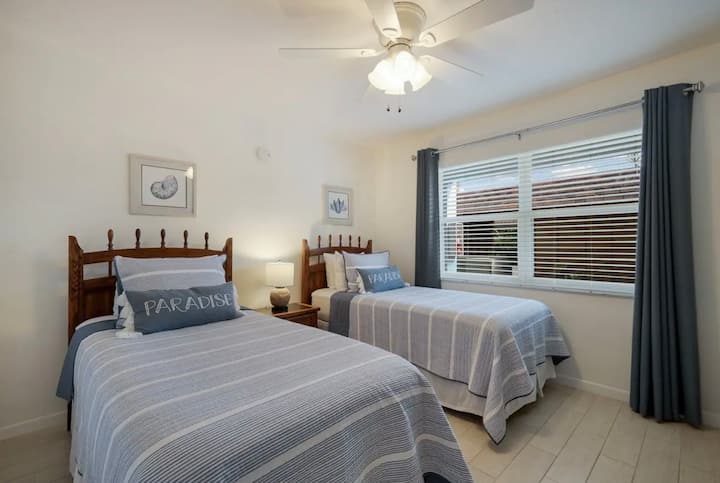 Second bedroom with two Twin XL beds and TV. 