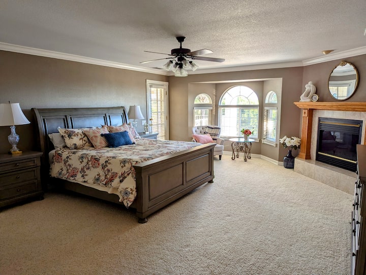 The large primary bedroom with a king sized bed, fireplace, private balcony with breathtaking views, and an ensuite that'll knock your socks off!