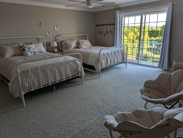 Pretty in pink! This suite features two queen sized beds, a private balcony, and an ensuite.