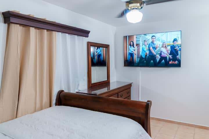 Bedroom 2, 65 inches tv and drawer.