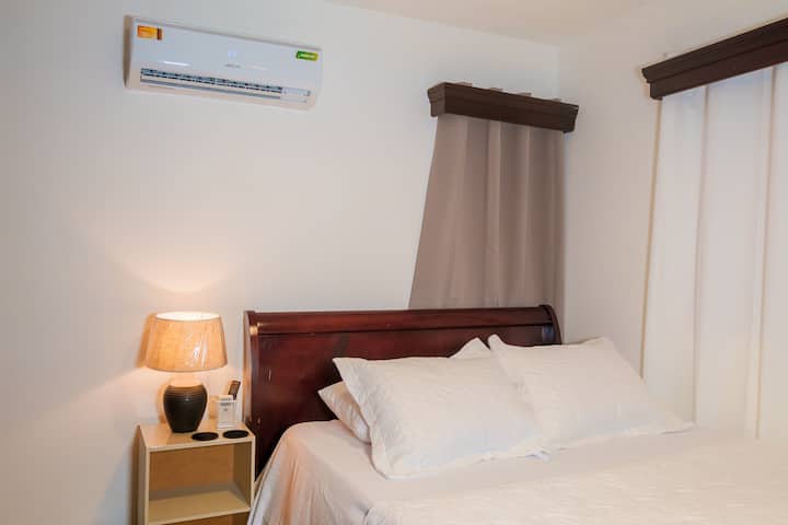 Queen size bed, air conditioner, ceiling fan, nigh table with light in Bedroom 3.