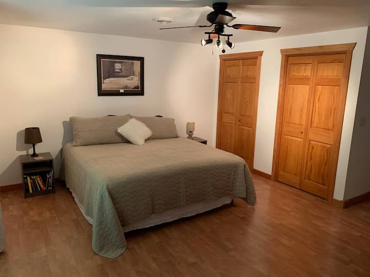 Spacious bedroom with plush king bed and balcony access — ideal for morning coffee, evening stargazing, and restful nights after a day of wine tasting or hiking.