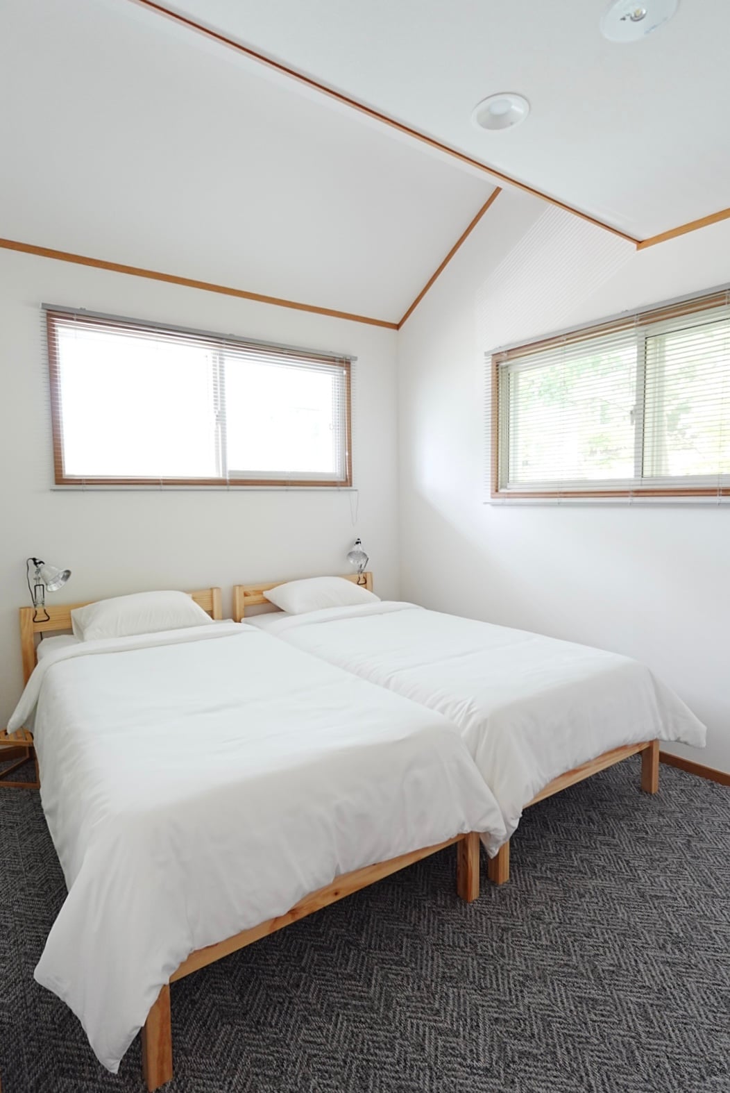 Each bedroom has two twin beds, loft storage, and an en suite sink and toilet.