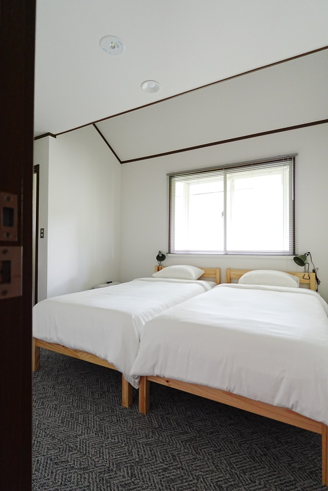 Each bedroom has two twin beds, loft storage, and an en suite sink and toilet