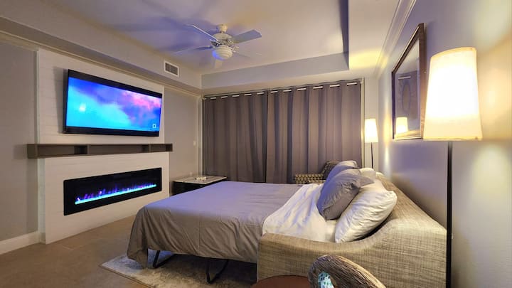 将客厅沙发改造成一张标准双人床，位于电壁炉前。 壁炉提供不断变化的色光功能和温暖的加热功能，为浪漫的夜晚氛围奠定了基础。 