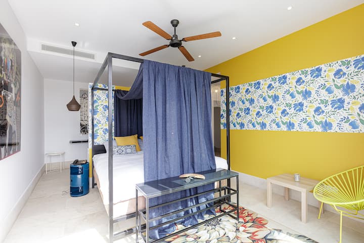 The bedroom features a king-size bed and an ensuite bathroom with a stand-up shower.