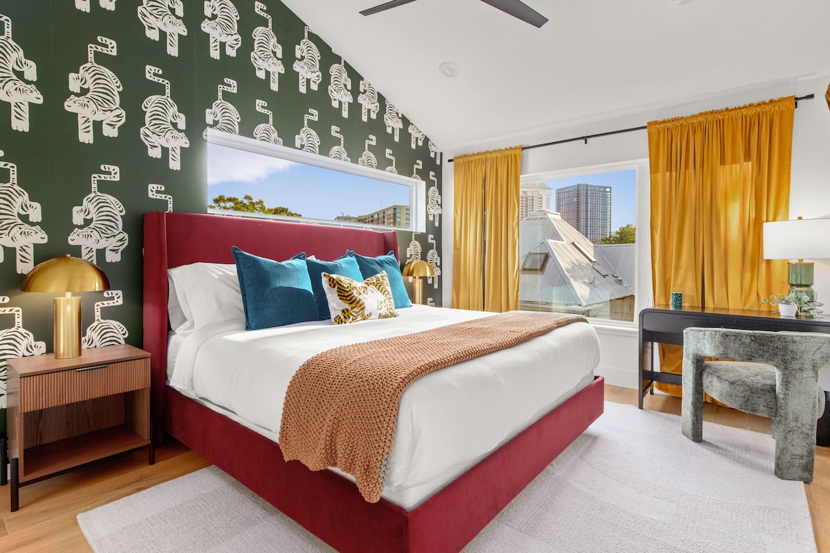 Relax in a stylish bedroom with luxe bedding and vibrant, playful decor.